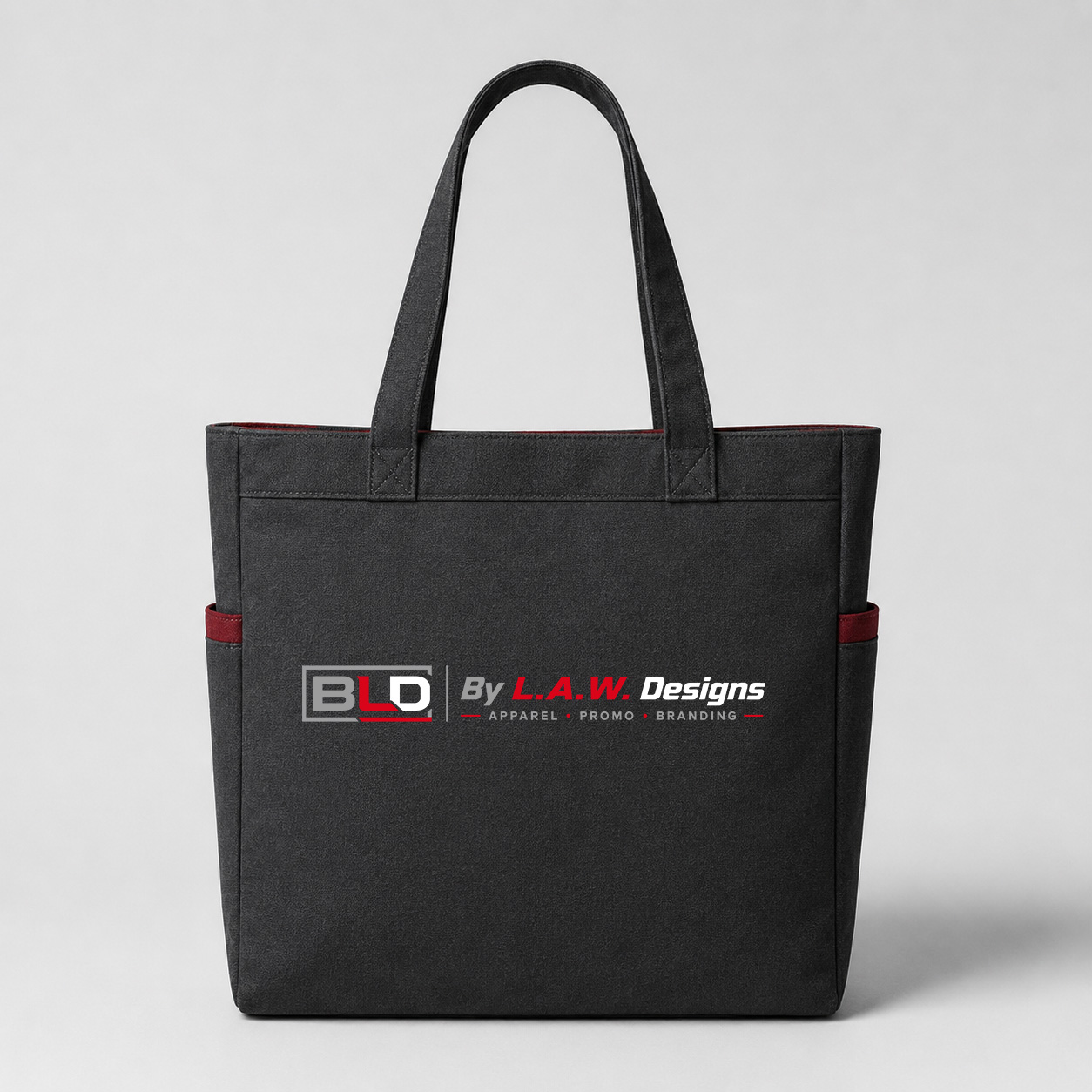 Reusable charcoal tote bag decorated with the official BLD logo