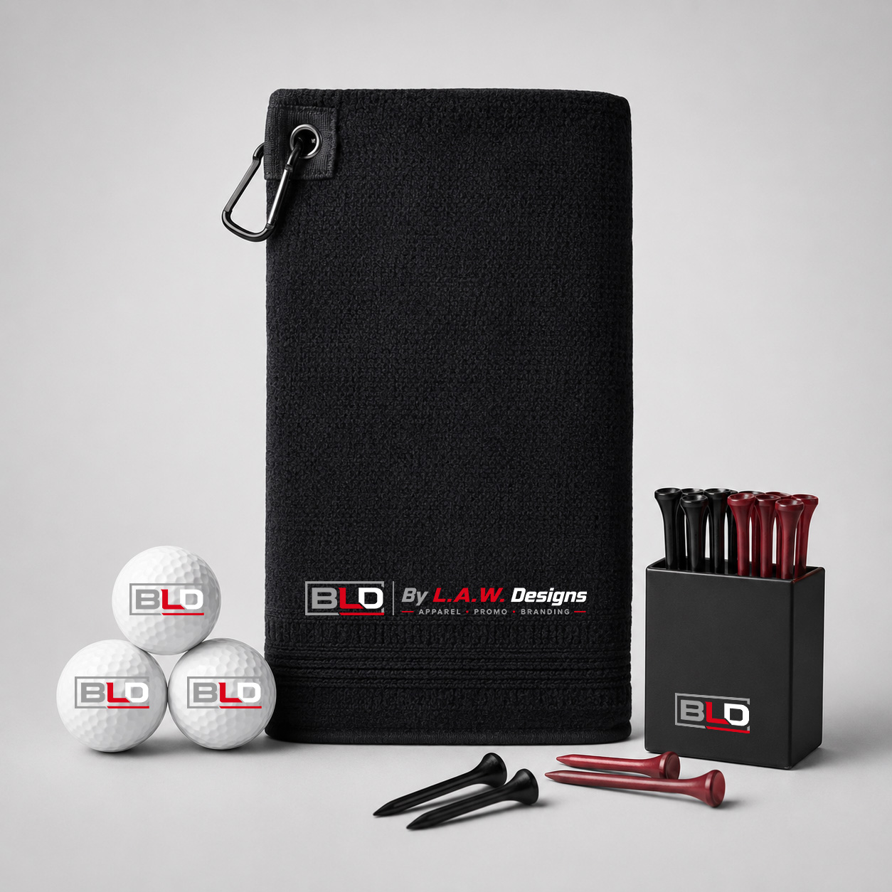 Promotional golf towel, balls and tees decorated with the official BLD logo